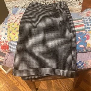Black and grey checked shorts with buttons .